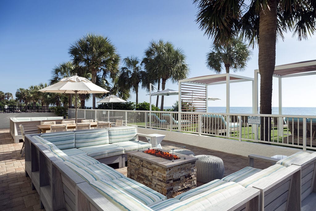 Couch around the fire pit on the pool deck